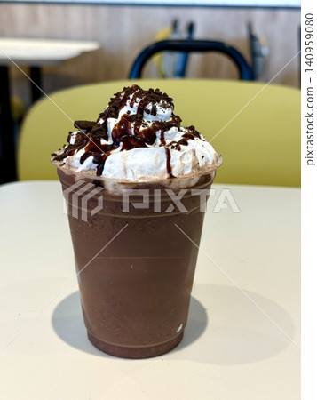 Chocolate-flavored frappuccino; iced coffee with iced café au lait and ice cream. Chocolate-flavored frappuccino; iced coffee with iced café au lait and ice cream. 140959080