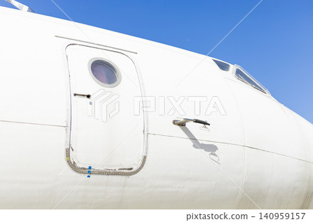 Close Up of White Airplane Cockpit Exterior and Passenger Door Close Up of White Airplane Cockpit Exterior and Passenger Door 140959157