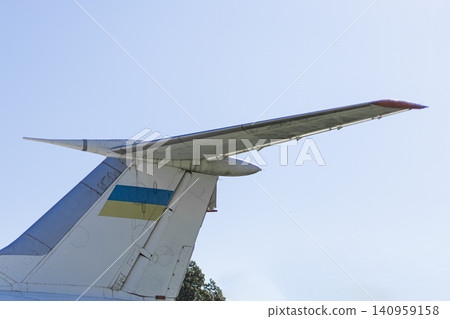 Tail Fin of Cargo Plane with Ukrainian Flag Against Blue Sky Tail Fin of Cargo Plane with Ukrainian Flag Against Blue Sky 140959158