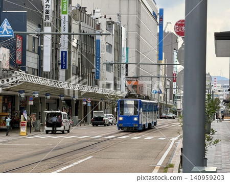 Streetcars running on the road; streetscape in front of Fukui Station and streetcars. Streetcars running on the road; streetscape in front of Fukui Station and streetcars. 140959203