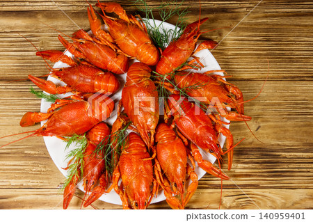 Boiled crayfish in plate on wooden table. Top view Boiled crayfish in plate on wooden table. Top view 140959401