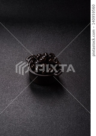 Black canned olives without pits for salads and snacks. Black olives without pits Black canned olives without pits for salads and snacks. Black olives without pits 140959560