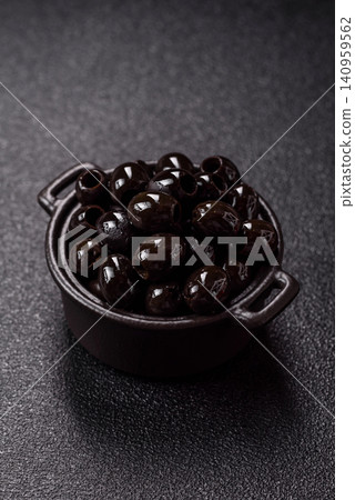 Black canned olives without pits for salads and snacks. Black olives without pits Black canned olives without pits for salads and snacks. Black olives without pits 140959562