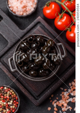 Black canned olives without pits for salads and snacks. Black olives without pits Black canned olives without pits for salads and snacks. Black olives without pits 140959564