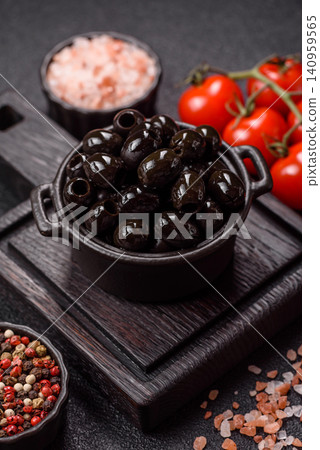 Black canned olives without pits for salads and snacks. Black olives without pits Black canned olives without pits for salads and snacks. Black olives without pits 140959565