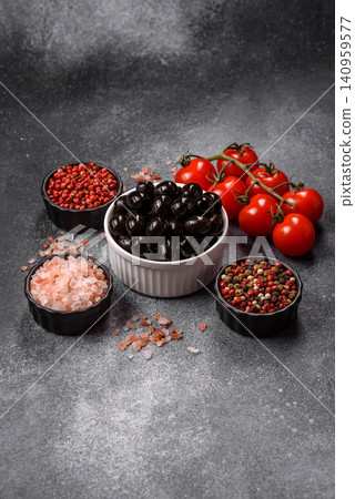 Black canned olives without pits for salads and snacks. Black olives without pits Black canned olives without pits for salads and snacks. Black olives without pits 140959577
