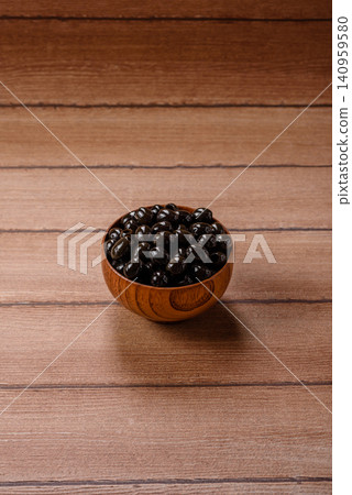 Black canned olives without pits for salads and snacks. Black olives without pits Black canned olives without pits for salads and snacks. Black olives without pits 140959580