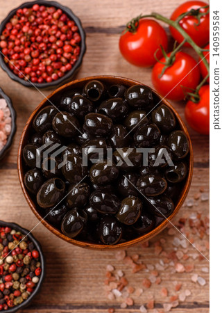 Black canned olives without pits for salads and snacks. Black olives without pits Black canned olives without pits for salads and snacks. Black olives without pits 140959584