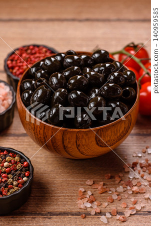 Black canned olives without pits for salads and snacks. Black olives without pits Black canned olives without pits for salads and snacks. Black olives without pits 140959585