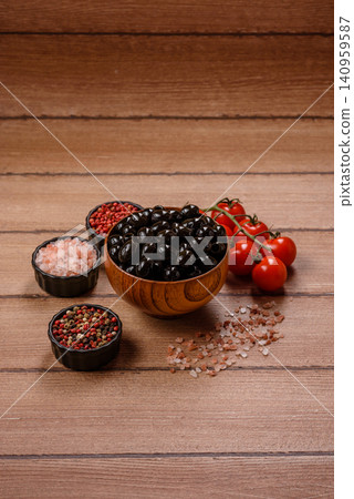 Black canned olives without pits for salads and snacks. Black olives without pits Black canned olives without pits for salads and snacks. Black olives without pits 140959587