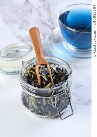 Blue butterfly pea tea in a glass jar and cup on marble background Blue butterfly pea tea in a glass jar and cup on marble background 140959594