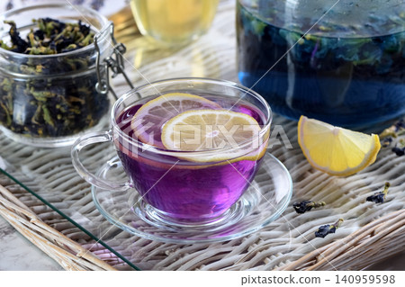 Purple butterfly pea flower tea with lemon slices in glass cup Purple butterfly pea flower tea with lemon slices in glass cup 140959598