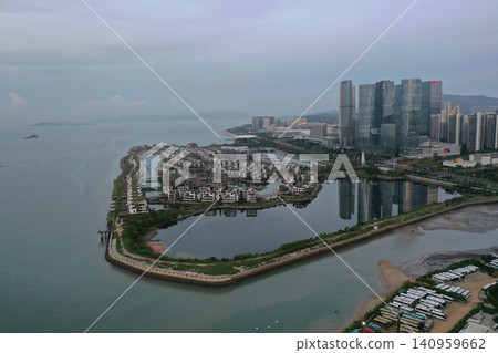 Aerial view of Xiamen, China, a modern waterfront district with a marina and skyscrapers. Aerial view of Xiamen, China, a modern waterfront district with a marina and skyscrapers. 140959662