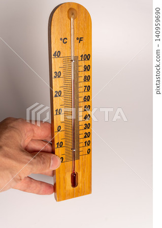 Wooden thermometer showing temperature on a scale in Celsius and Fahrenheit Wooden thermometer showing temperature on a scale in Celsius and Fahrenheit 140959690