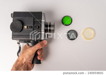 Vintage movie camera with light filters on a table in a studio 140959691