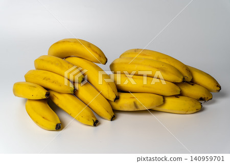 Fresh bananas piled on a flat surface ready for use in various recipes Fresh bananas piled on a flat surface ready for use in various recipes 140959701