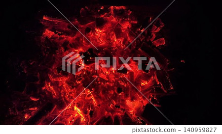Close up of glowing charcoal embers burning with red and orange tones at night. Soft heat and shimmering texture create magical atmosphere. Warm abstract scene symbolizing warmth and quiet at nature Close up of glowing charcoal embers burning with red and orange tones at night. Soft heat and shimmering texture create magical atmosphere. Warm abstract scene symbolizing warmth and quiet at nature 140959827