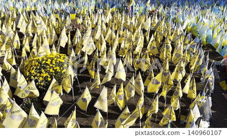 Many small flags of Ukraine with names of the dead war against russia. Memorial of the fallen soldiers, children, women in the center of Kyiv. Concept of tragedy and misfortune. Closeup Many small flags of Ukraine with names of the dead war against russia. Memorial of the fallen soldiers, children, women in the center of Kyiv. Concept of tragedy and misfortune. Closeup 140960107