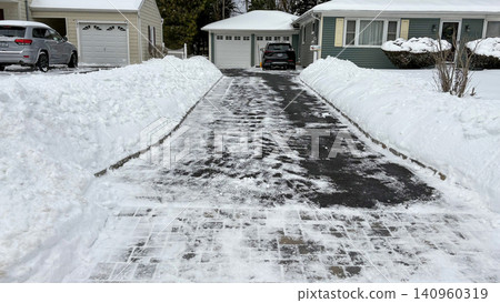Residential Driveway is clear of snow with snow piled on both sides Residential Driveway is clear of snow with snow piled on both sides 140960319