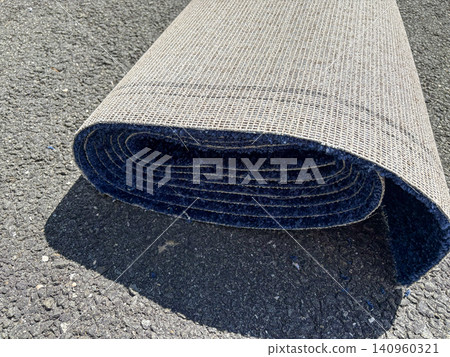 Roll of Blue Carpet on a Driveway Ready to be Installed Roll of Blue Carpet on a Driveway Ready to be Installed 140960321