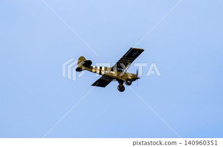 Vintage Airplane Flying in a Clear Sky During Midday Vintage Airplane Flying in a Clear Sky During Midday 140960351