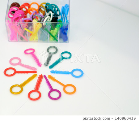 Colorful orthodontic elastics and ligatures arranged on table for dental treatment and braces care Colorful orthodontic elastics and ligatures arranged on table for dental treatment and braces care 140960439
