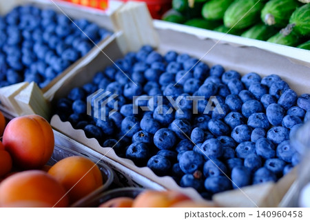 Fresh blueberries in wooden crate at local farmers market displayed as healthy seasonal berries rich in vitamins and natural flavor Fresh blueberries in wooden crate at local farmers market displayed as healthy seasonal berries rich in vitamins and natural flavor 140960458