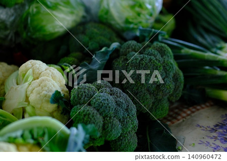 broccoli at market. Fresh green broccoli in rustic wooden box on dark background. broccoli at market. Fresh green broccoli in rustic wooden box on dark background. 140960472