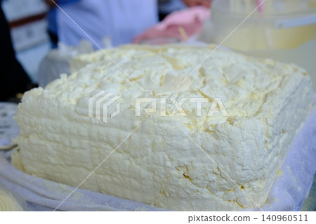 cottage cheese market. a large piece of cottage cheese on the store counter, homemade, natural cottage cheese market. a large piece of cottage cheese on the store counter, homemade, natural 140960511