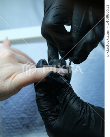 woman hands with light pink manicure on the nails. Skin care for hands, manicure and beauty treatment. Elegant and graceful hands with slender graceful fingers 140960512