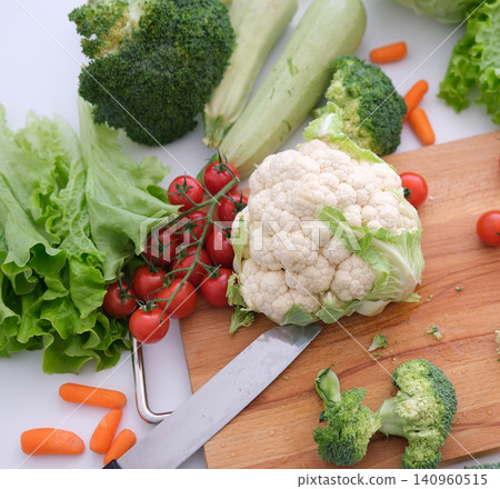 cauliflower other vegetables cutting board Chopped broccoli and other vegetables on wooden cutting board 140960515