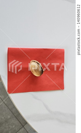 Traditional baked walnut shaped cookies with sweet condensed milk filling placed on red napkin in cozy homemade dessert and bakery atmosphere 140960612