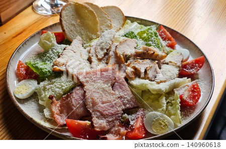Salad caesar with chicken, tomato, iceberg and croutons Salad caesar with chicken, tomato, iceberg and croutons 140960618