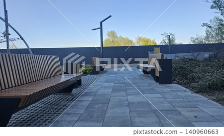 Modern bench in a park - Design in wood and concrete Modern bench in a park - Design in wood and concrete 140960663