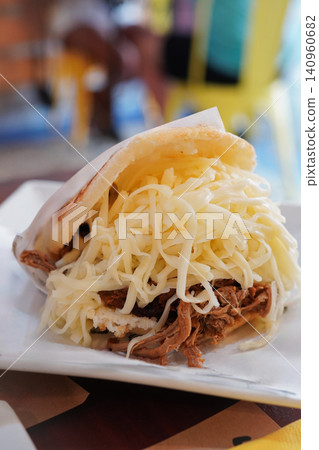 Arepa Perua, a hugely popular national dish of Venezuela, is a corn flour bread overflowing with various toppings. Arepa Perua, a hugely popular national dish of Venezuela, is a corn flour bread overflowing with various toppings. 140960682