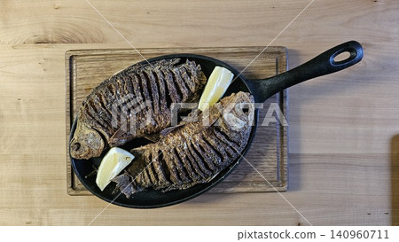 Grilled Whole Fish With Lemon And Herbs On A Plate Grilled Whole Fish With Lemon And Herbs On A Plate 140960711