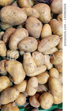 Texture of natural yellow beautiful ripe tasty healthy starchy potatoes fresh in the ground. The background. Texture of natural yellow beautiful ripe tasty healthy starchy potatoes fresh in the ground. The background. 140960808