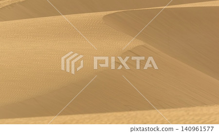 A minimalist perspective on the vast Viana desert landscape in Boa Vista, Cape Verde. The scene is a striking abstract composition formed by the golden sand dunes. A minimalist perspective on the vast Viana desert landscape in Boa Vista, Cape Verde. The scene is a striking abstract composition formed by the golden sand dunes. 140961577