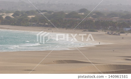 A minimalist perspective on the vast Viana desert landscape in Boa Vista, Cape Verde. The scene is a striking abstract composition formed by the golden sand dunes. A minimalist perspective on the vast Viana desert landscape in Boa Vista, Cape Verde. The scene is a striking abstract composition formed by the golden sand dunes. 140961581