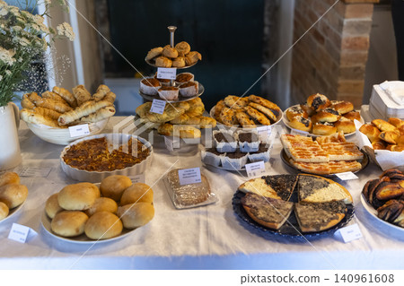 Bakery stall displaying fresh breads, quiches, cakes, and treats Bakery stall displaying fresh breads, quiches, cakes, and treats 140961608