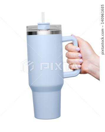 Female Hand Holding 40 oz blue tumbler. Tumbler With Handle, Travel Mug Straw Covers Cup with Lid Female Hand Holding 40 oz blue tumbler. Tumbler With Handle, Travel Mug Straw Covers Cup with Lid 140961685