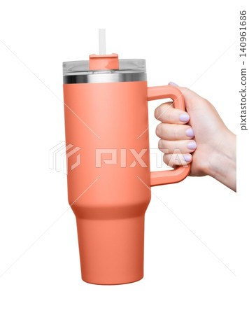 Female Hand Holding 40 oz orange tumbler. Tumbler With Handle, Travel Mug Straw Covers Cup with Lid Female Hand Holding 40 oz orange tumbler. Tumbler With Handle, Travel Mug Straw Covers Cup with Lid 140961686