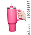 Female Hand Holding 40 oz pink tumbler. Tumbler With Handle, Travel Mug Straw Covers Cup with Lid 140961687