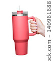Female Hand Holding 40 oz red tumbler. Tumbler With Handle, Travel Mug Straw Covers Cup with Lid 140961688