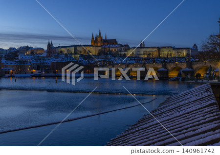 Prague Castle, Charles Bridge across Vltava River, winter evening 140961742