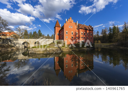 Cervena Lhota castle reflecting in pond, blue sky Cervena Lhota castle reflecting in pond, blue sky 140961765