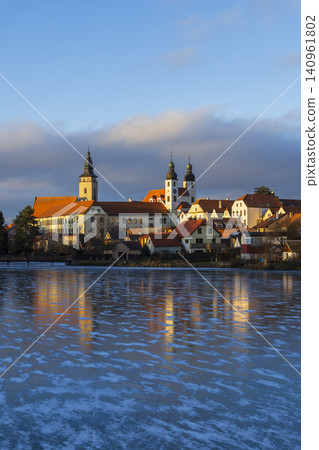Telc townscape reflecting on frozen lake during winter Telc townscape reflecting on frozen lake during winter 140961802