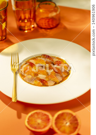 Fresh fish carpaccio with blood orange segments and citrus reduction Fresh fish carpaccio with blood orange segments and citrus reduction 140961906