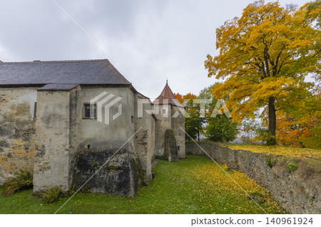 Nove Hrady castle autumn wall and vibrant yellow tree Nove Hrady castle autumn wall and vibrant yellow tree 140961924