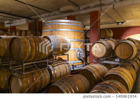 Wooden barrels and vats storing wine in a traditional cellar Wooden barrels and vats storing wine in a traditional cellar 140961934